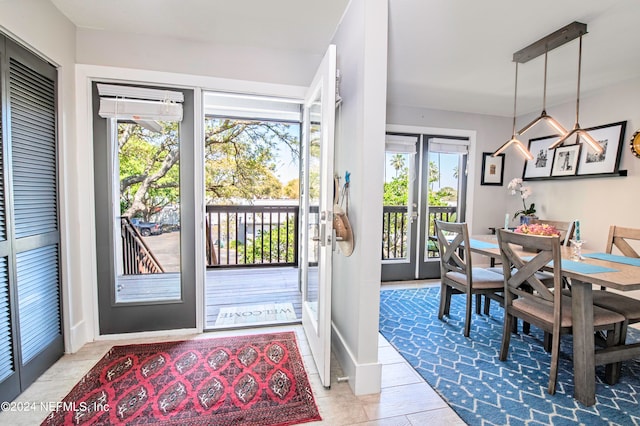 entryway with a notable chandelier, french doors, and a wealth of natural light