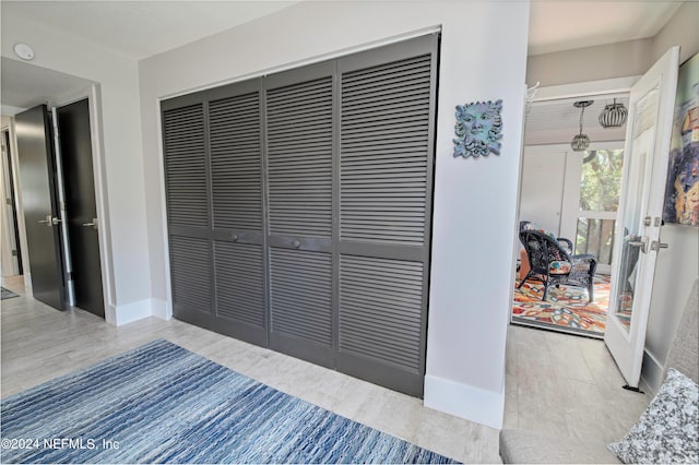 interior space featuring light hardwood / wood-style floors, a closet, and french doors