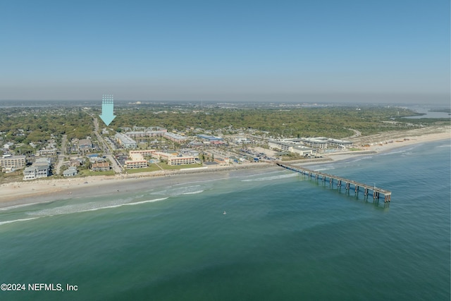 birds eye view of property featuring a beach view and a water view