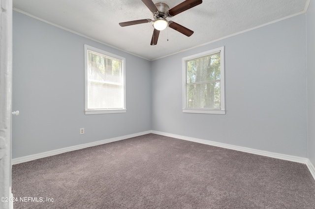 carpeted spare room with a ceiling fan, baseboards, ornamental molding, and a textured ceiling