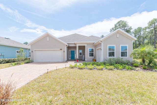 ranch-style home featuring a front yard and a garage