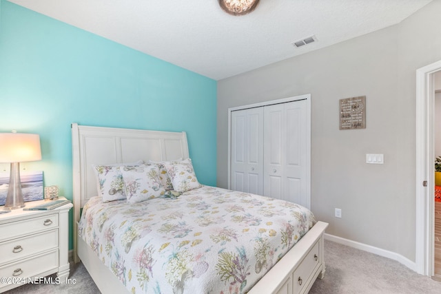 carpeted bedroom with a closet