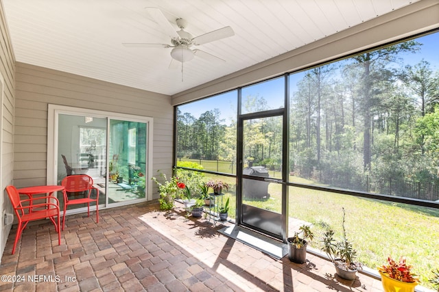 sunroom / solarium with a wealth of natural light and ceiling fan