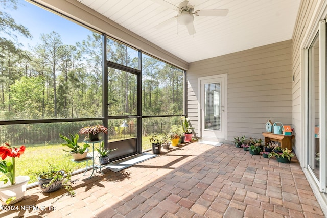 unfurnished sunroom featuring plenty of natural light and ceiling fan