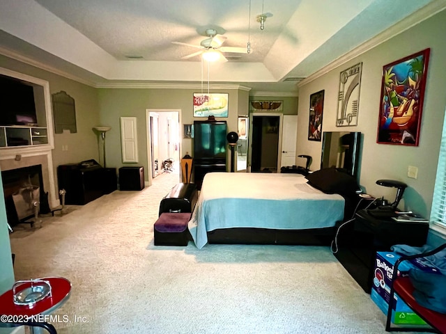 carpeted bedroom featuring crown molding, ceiling fan, and a tray ceiling