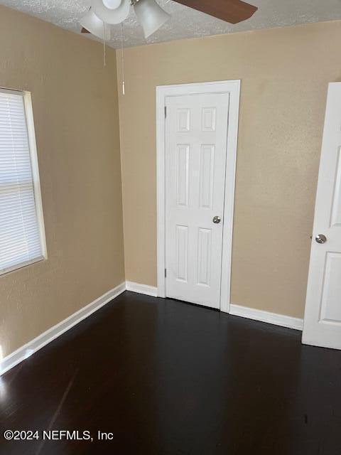 spare room with a textured ceiling and ceiling fan