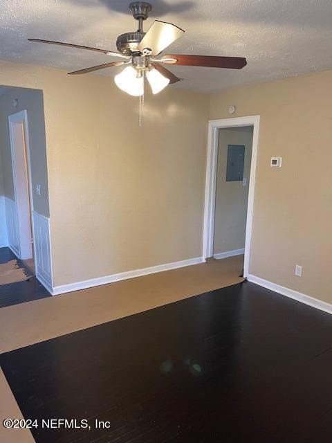 spare room featuring a textured ceiling and ceiling fan