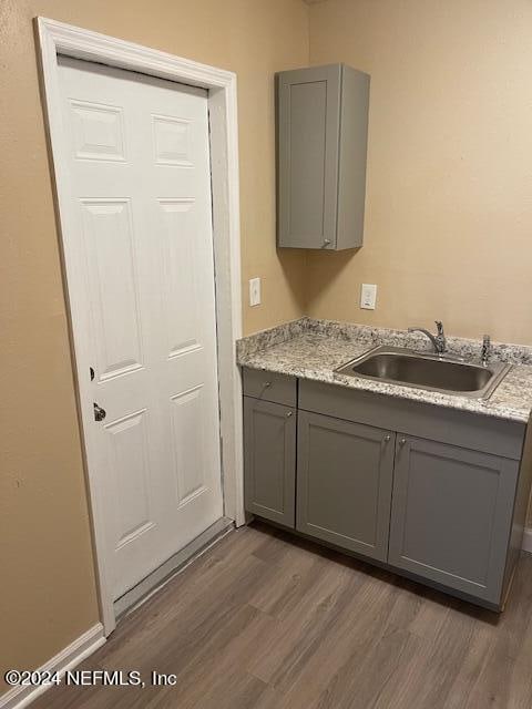 interior space with hardwood / wood-style floors and sink