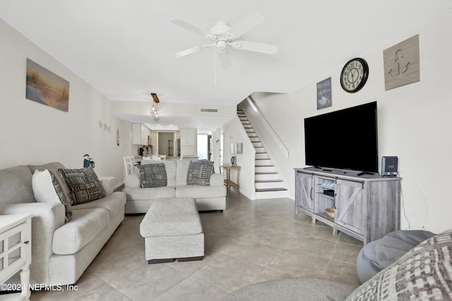 tiled living room featuring ceiling fan