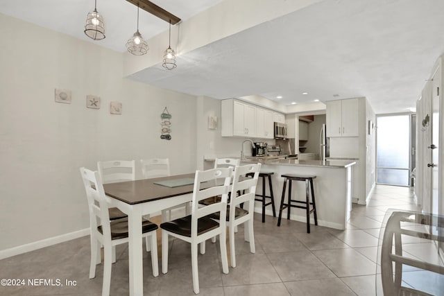 dining room featuring light tile flooring and sink