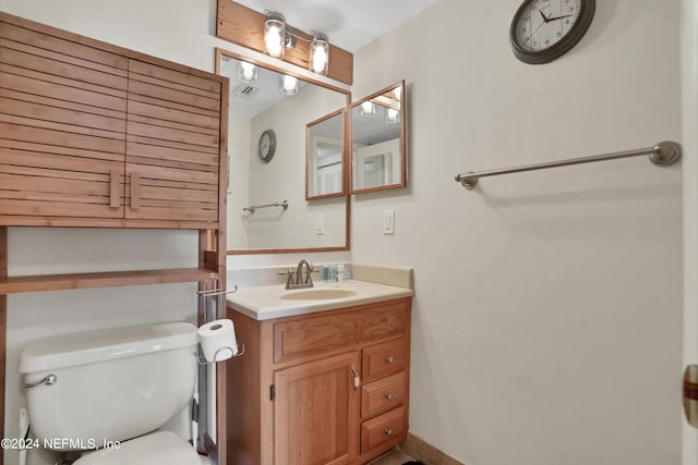 bathroom featuring oversized vanity and toilet