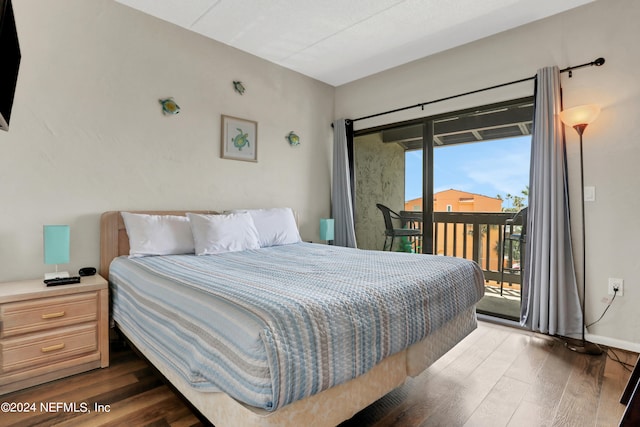 bedroom featuring dark hardwood / wood-style flooring and access to exterior