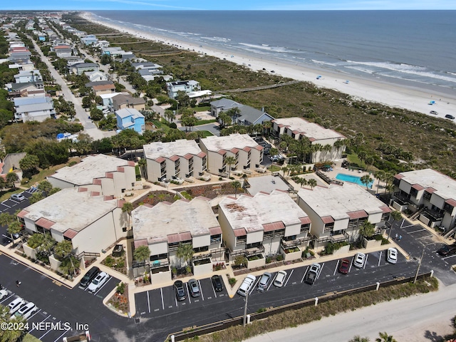 birds eye view of property with a water view and a view of the beach