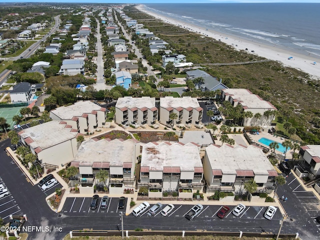 drone / aerial view featuring a water view and a beach view