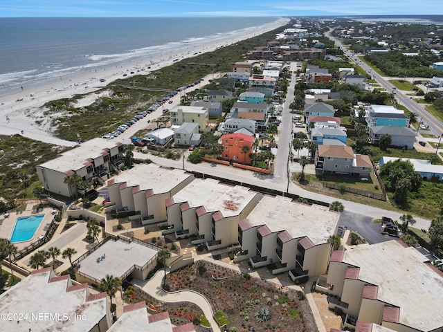 birds eye view of property with a beach view and a water view