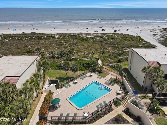 birds eye view of property with a water view and a view of the beach