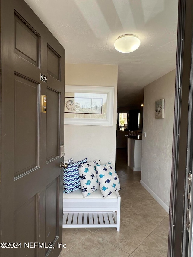 hall featuring light tile floors