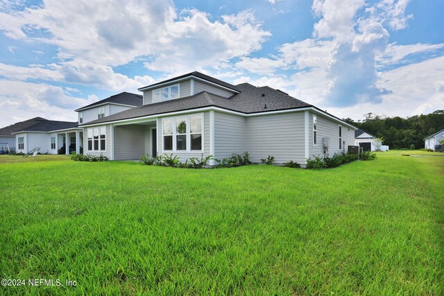 view of side of home with a yard