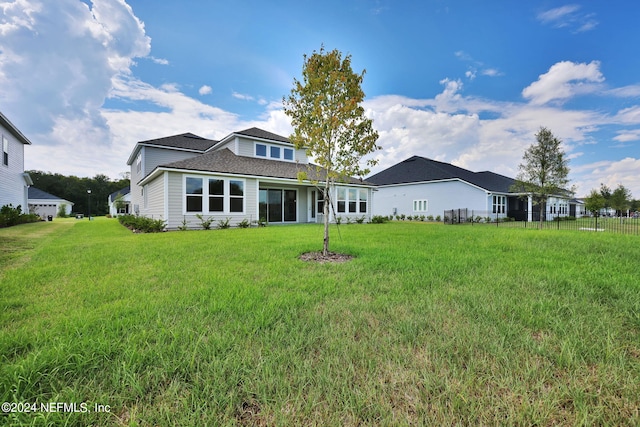 view of front of property with a front yard and fence