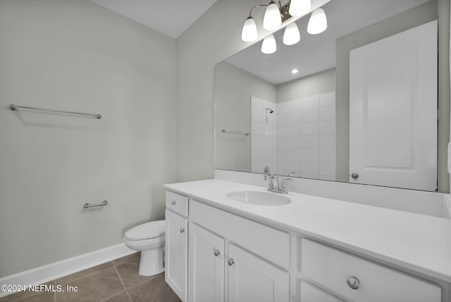 full bath with baseboards, tiled shower, toilet, tile patterned flooring, and vanity