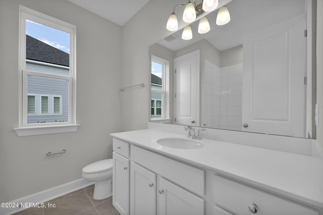 bathroom featuring toilet, vanity, and tile patterned floors