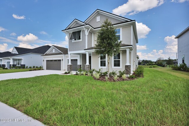 craftsman-style home with a garage and a front yard