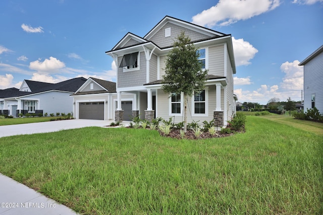 view of front of property with driveway, stone siding, a garage, and a front lawn