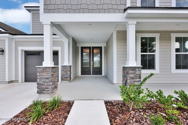 doorway to property featuring covered porch