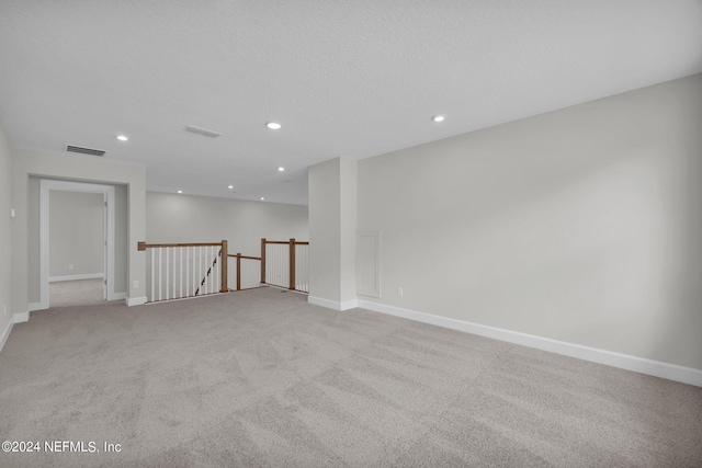 unfurnished room featuring light colored carpet, recessed lighting, visible vents, and baseboards