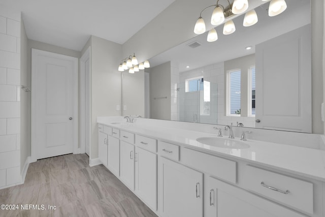 bathroom featuring tile patterned flooring and dual bowl vanity