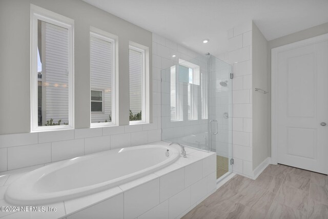 bathroom featuring tile patterned flooring and plus walk in shower