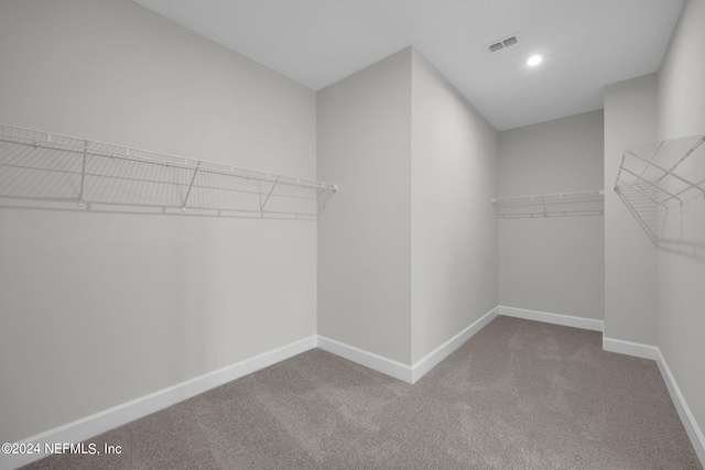 spacious closet with carpet floors and visible vents