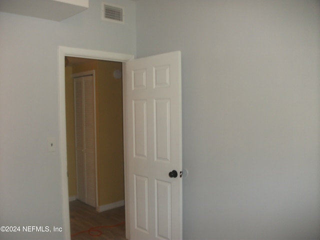 hallway with hardwood / wood-style floors