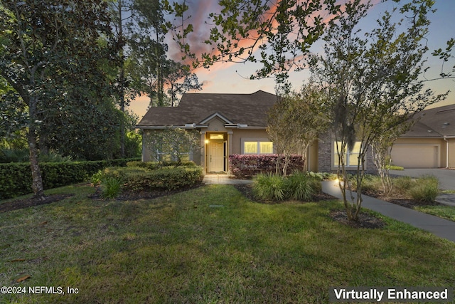 view of front of property featuring a lawn and a garage