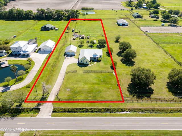 birds eye view of property with a rural view