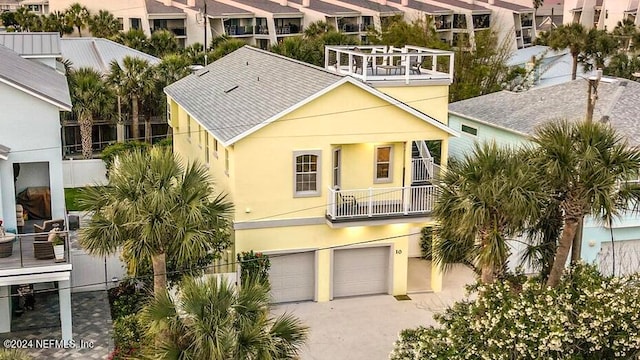 view of front facade featuring a garage and a balcony