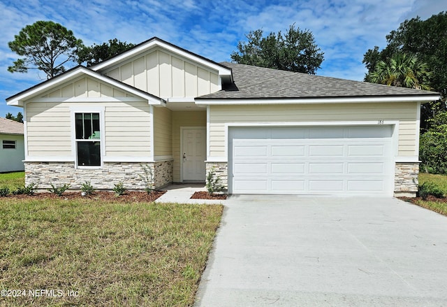 view of front facade featuring a front yard and a garage