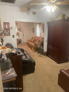 living room featuring ceiling fan and carpet flooring