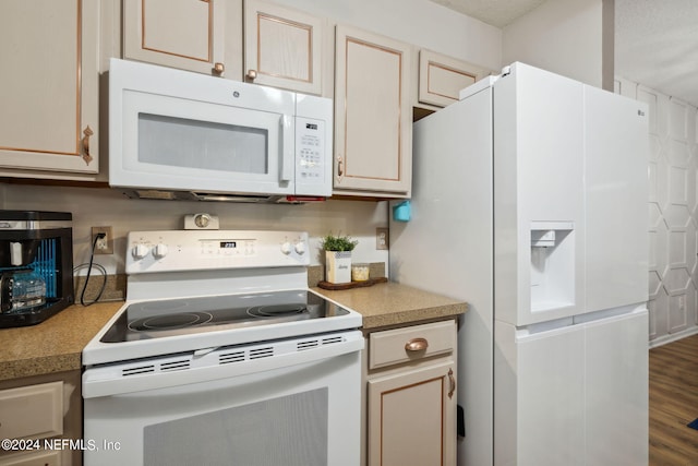 kitchen featuring hardwood / wood-style floors, white appliances, and a textured ceiling