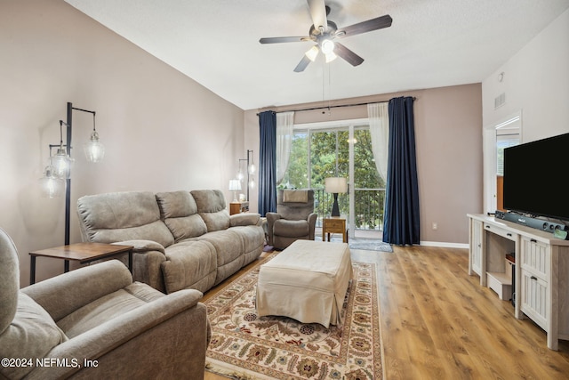 living room featuring light hardwood / wood-style floors and ceiling fan