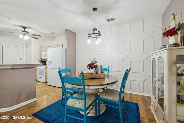 dining room with ceiling fan and light wood-type flooring