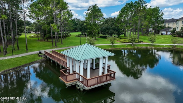 dock area featuring a water view and a yard