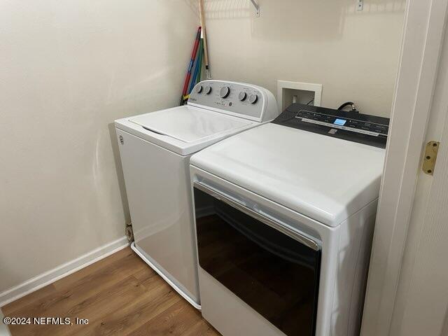 laundry room featuring separate washer and dryer and dark hardwood / wood-style floors