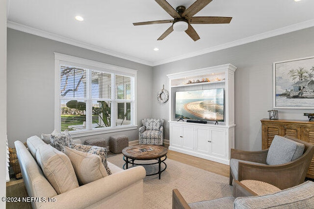 living room with ornamental molding, light hardwood / wood-style flooring, and ceiling fan