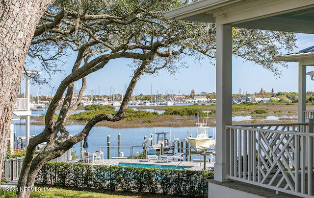 exterior space featuring a boat dock and a water view