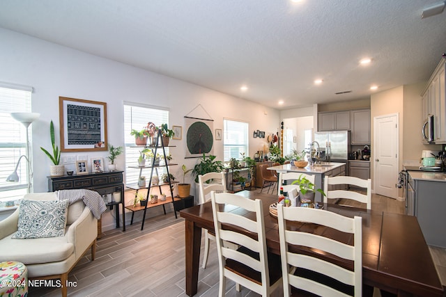 dining room with dark hardwood / wood-style floors, a textured ceiling, and sink