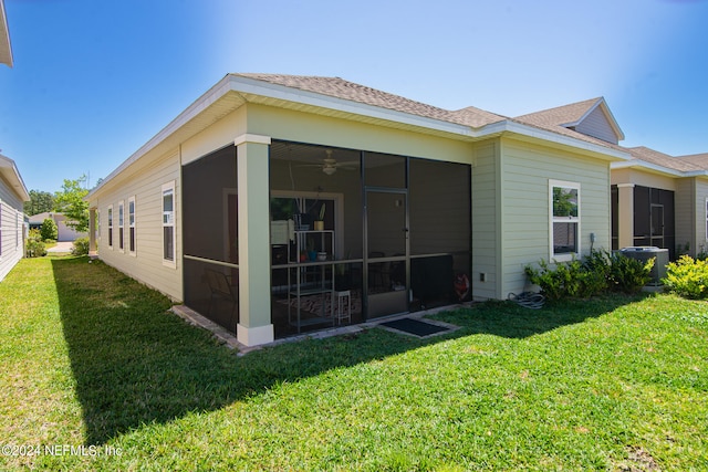 view of side of home featuring a lawn, a sunroom, and central air condition unit