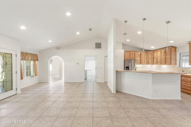 kitchen featuring decorative light fixtures, stainless steel refrigerator with ice dispenser, and light tile floors