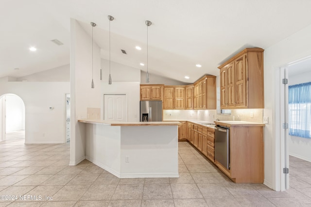 kitchen featuring kitchen peninsula, pendant lighting, light tile floors, appliances with stainless steel finishes, and tasteful backsplash