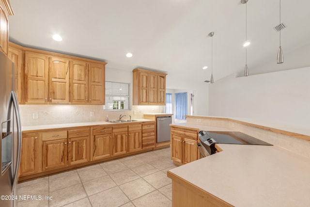 kitchen featuring decorative light fixtures, sink, stainless steel appliances, light tile floors, and tasteful backsplash